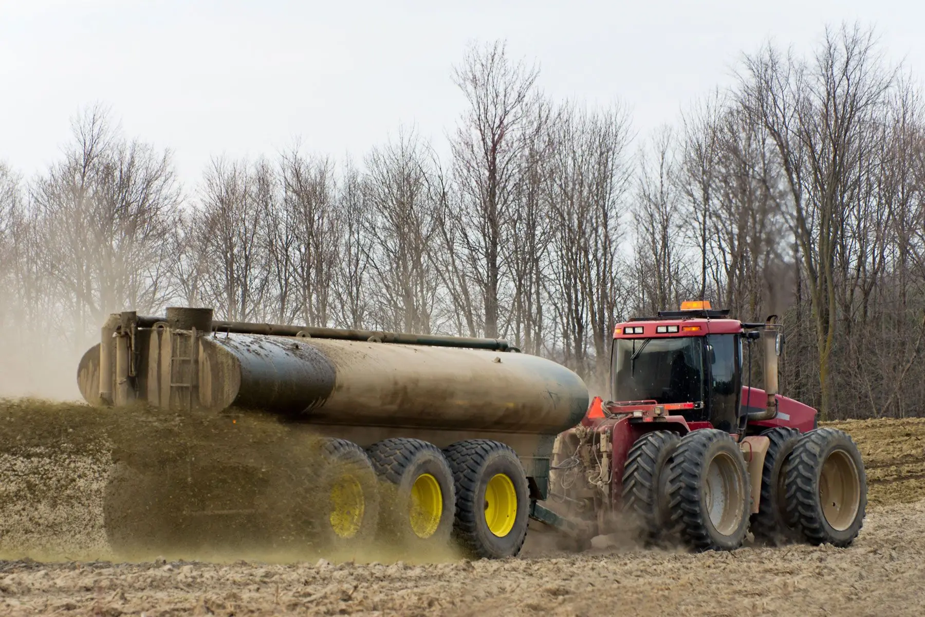 Tractor applying liquid manure – a practice that requires odour control.