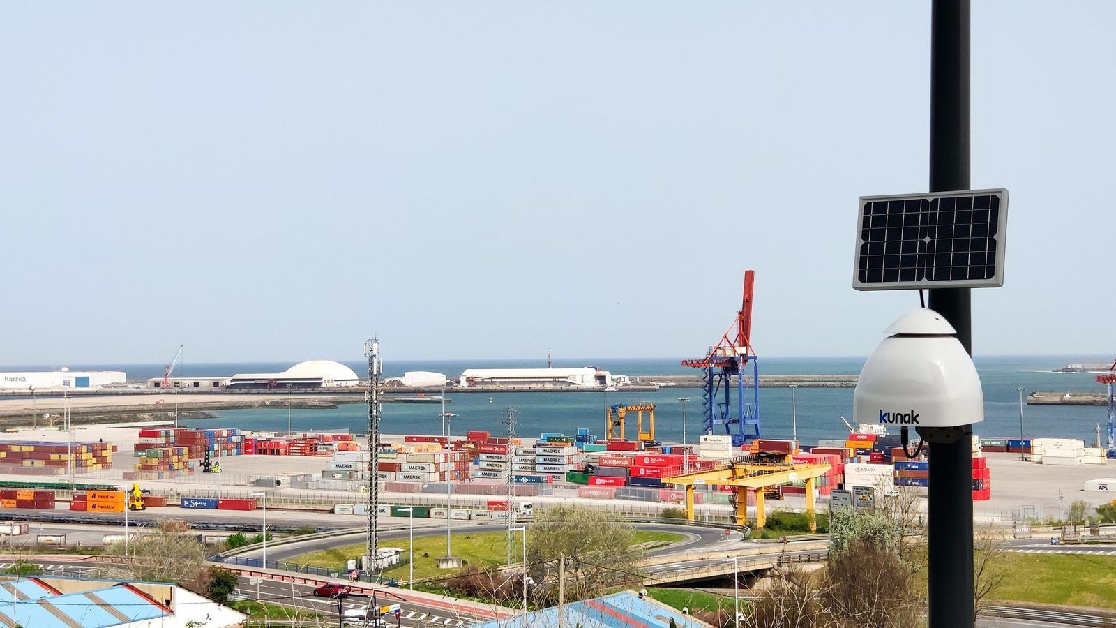Solar-powered Kunak AIR Pro air quality sensor installed in a port environment. - Kunak