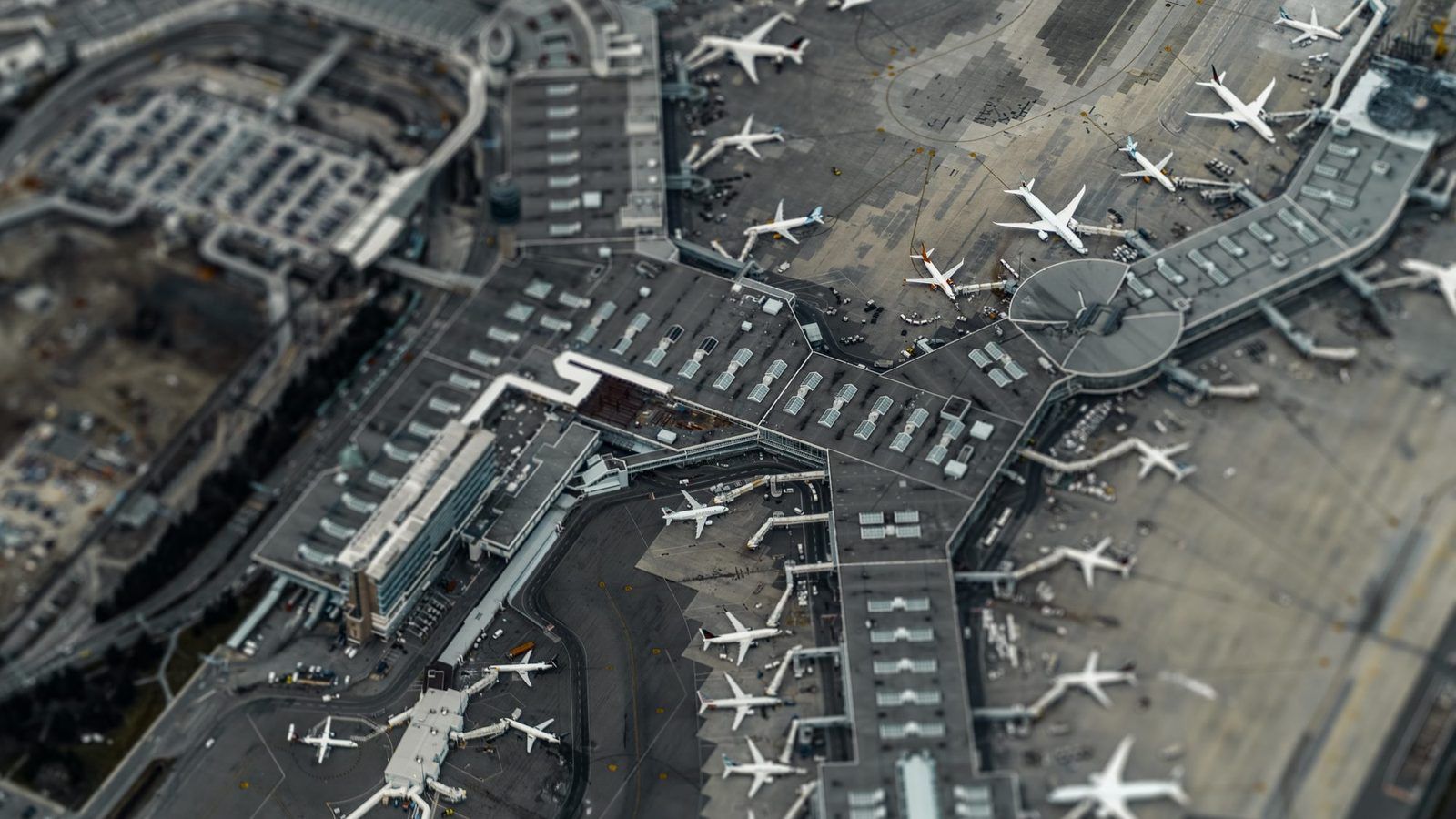 Aerial view of an airport, one of the environments where the monitoring objective shapes the choice of air quality sensor. - Kunak