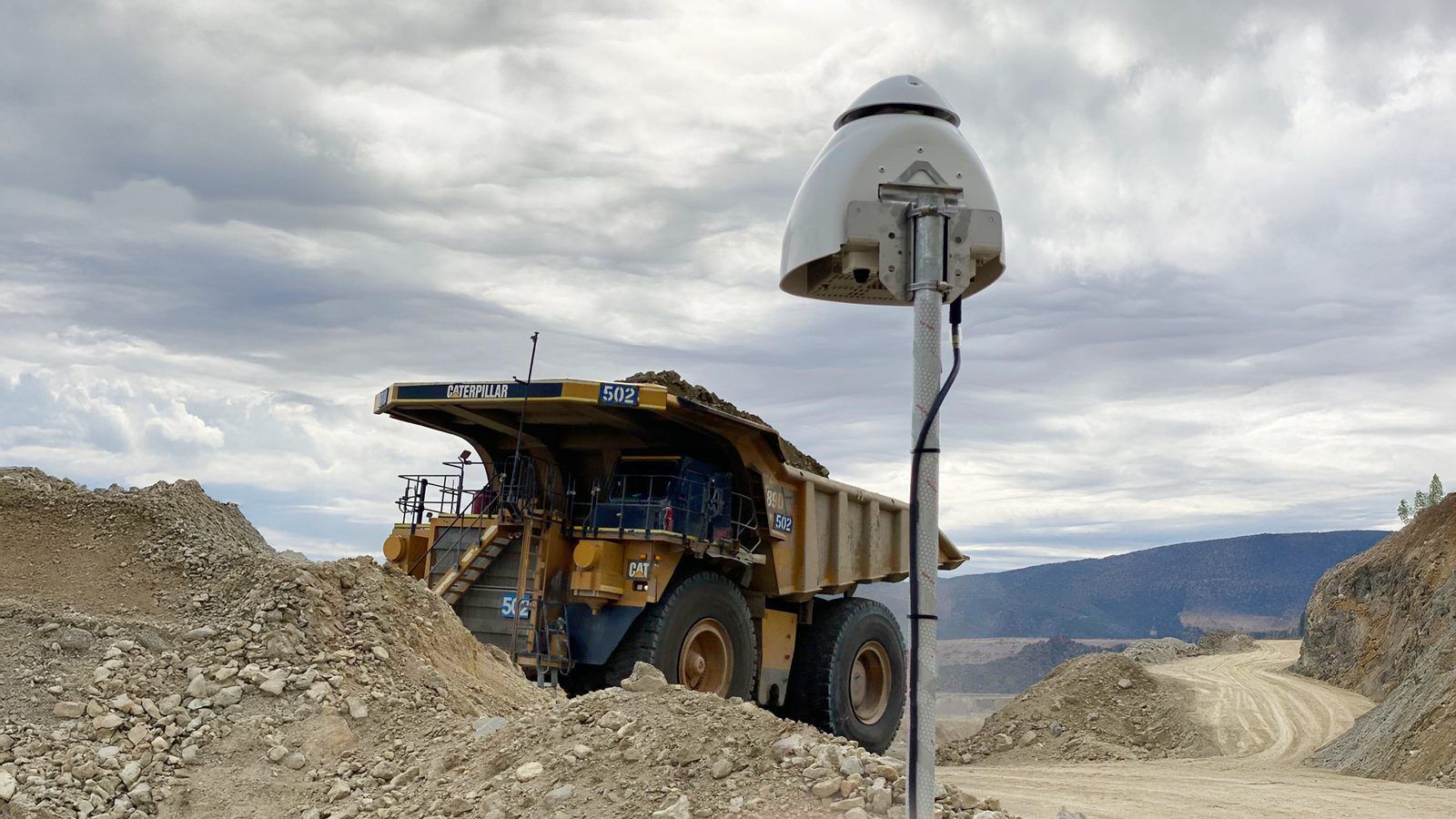 Kunak dust monitoring sensor installed beside a haul road at an open-pit mine.